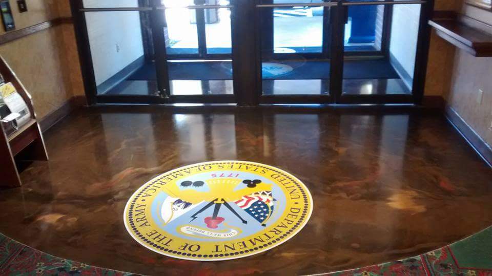 Metallic epoxy floor with custom Army seal design